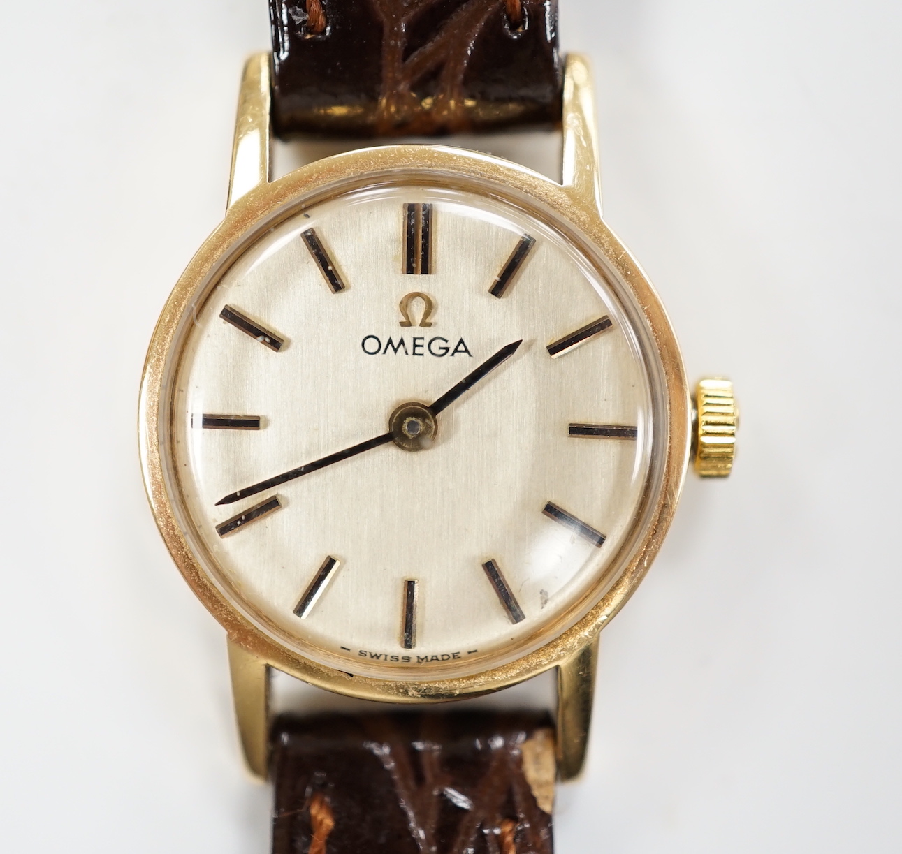 A lady's 1970's 9ct gold Omega manual wind wrist watch, with case back inscription, on associated leather strap, in Garrards box.